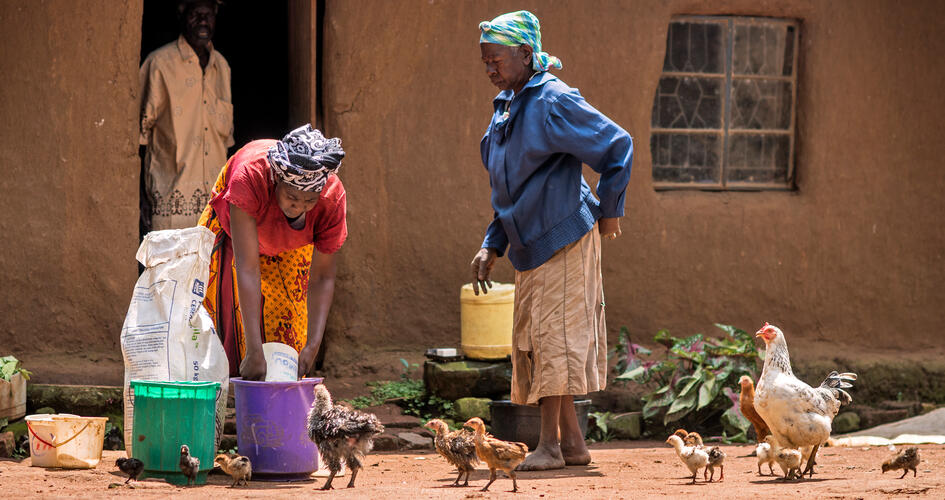 Anastancia Kulundu transferring fertilizer into a bucket