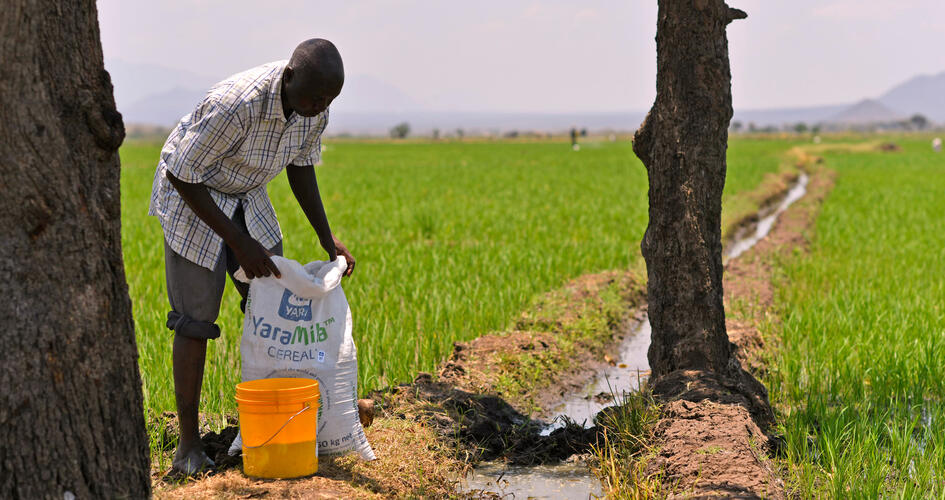 Jonathan Hudson Mujema with a Yara fertilizer bag in a farm