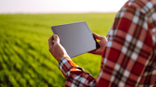 farmer hands with tablet in field