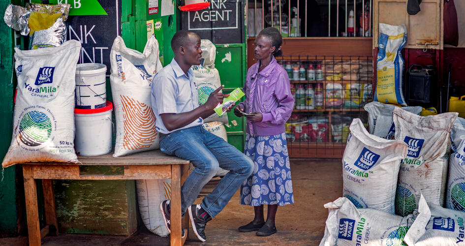 Agnes Atoko talking to a Yara personnel outside a store