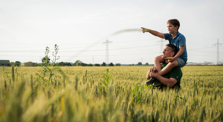 Father and son in a field