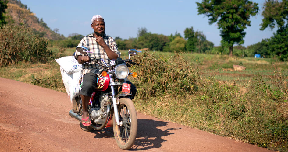 Elibariki Kimaro driving with Yara fertilizer bags on his motorbike